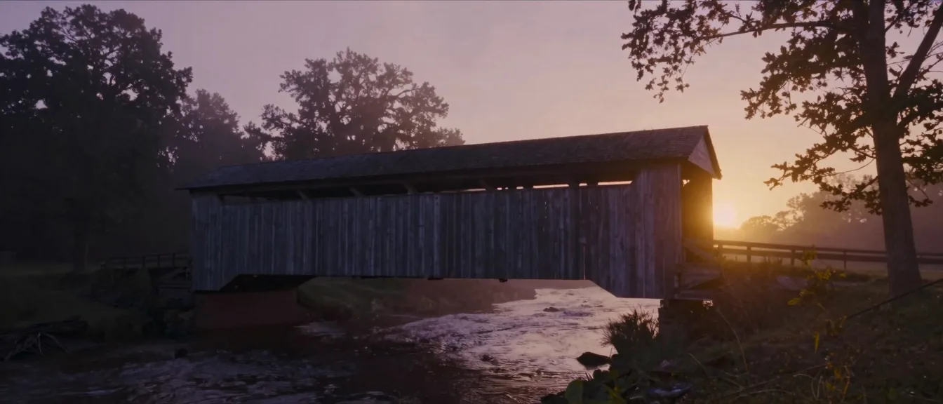 A wooden covered bridge spanning a Piedmont creek at dawn